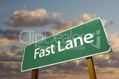 Fast Lane Green Road Sign Over Clouds