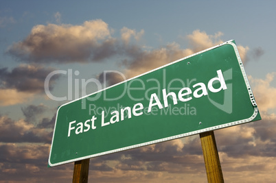 Fast Lane Ahead Green Road Sign Over Clouds