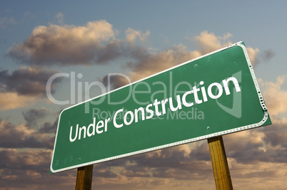 Under Construction Green Road Sign Over Clouds