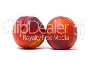 Two juicy nectarines on a white background