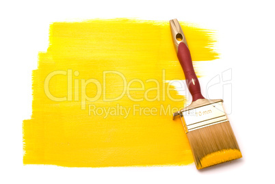 Professional brush with yellow paint on the white background