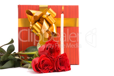 Red roses and gift boxes on a studio white background.