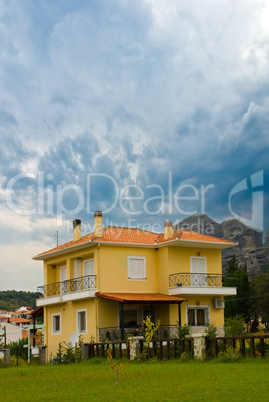 The European house. Yellow home with red tiled roof.