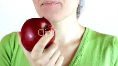 Closeup of young woman eating an apple