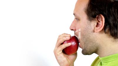 Closeup of young man eating an apple