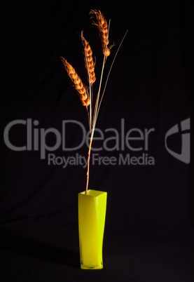 Decorative ornament from three grain cereals in a yellow vase