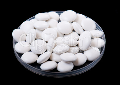 white pills isolated on a black