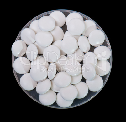 white pills isolated on a black