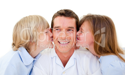 Cute siblings kissing their father