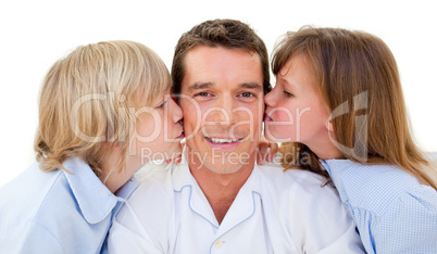 Adorable siblings kissing their father