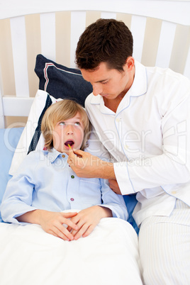 Worried father checking his son's temperature