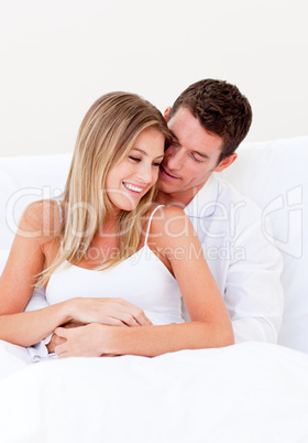 Portrait of a loving couple sitting on bed