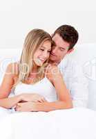 Portrait of a loving couple sitting on bed