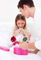 Bright husband giving a present to his wife