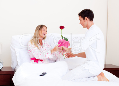 Adorable husband giving a present to his wife