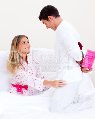 Lovely husband giving a present to his wife