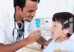 Attractive doctor giving medicine to a little boy