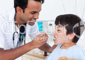 Charismatic doctor giving medicine to a little boy