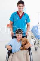 Portrait of a cute little boy sitting on wheelchair and a doctor