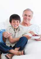 Cute little boy taking care of his grandfather