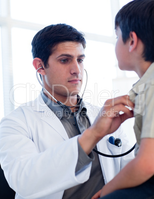 Portrait of a serious doctor examining a little boy