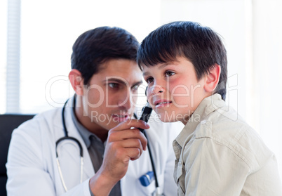 Young doctor examining little boy's ears