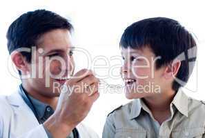 Self-assured doctor giving medicine to a little boy
