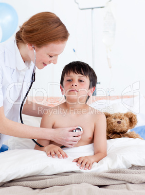 Attentive doctor examining a little boy