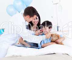 Smiling doctor playing with a little boy and his mother