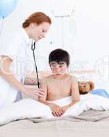Beautiful doctor examining a little boy