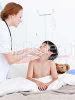 Female doctor examining a little boy
