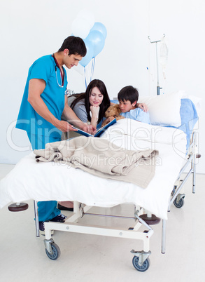 Cute little boy, his mother and a doctor having a talk