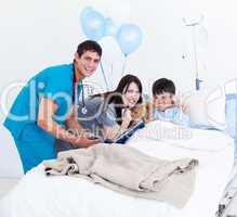 Smiling little boy, his mother and a doctor having a talk