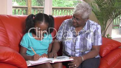 Grandmother helps granddaughter with homework