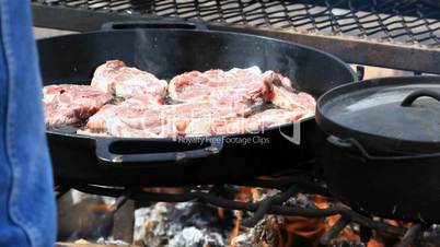 Cooking lamb chops over outdoor grill