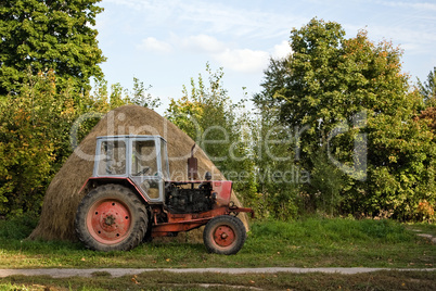 Old tractor and haystack