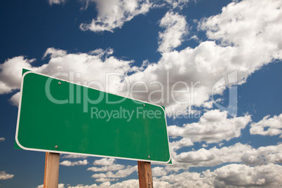 Blank Green Road Sign Over Clouds with Text Room