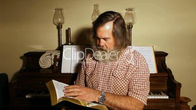 Reading Bible by piano