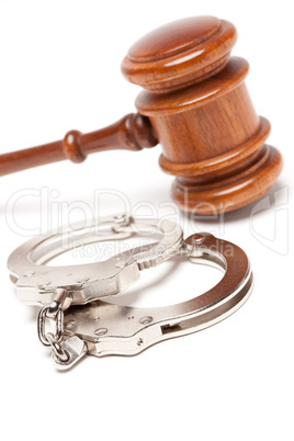 Gavel and Handcuffs on White