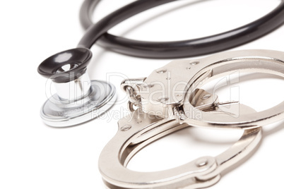 Stethoscope and Handcuffs on White