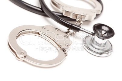 Stethoscope and Handcuffs on White