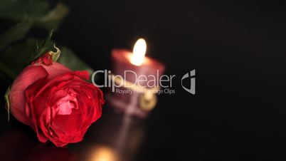 Red rose and candle.