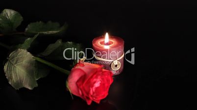 Red rose and candle.