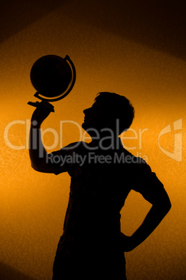 Back light - silhouette of man holding globe