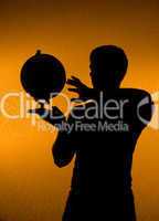 Discover the world - silhouette of man holding globe