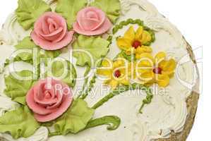 Close-up of tasty cake with cream, pink roses