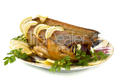 Tasty bloated sheatfish with lemon and parsley
