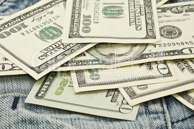 US dollar banknotes and jeans