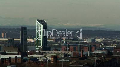 View of Liverpool waterfront buildings with snow topped Welsh mountains in the background 3