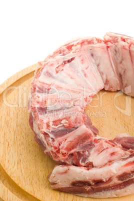 Raw Pork ribs with meat on round hardboard